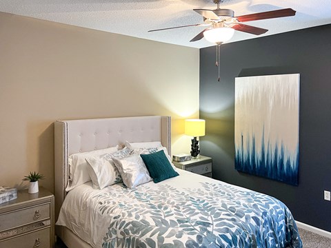 a bedroom with a bed and a ceiling fan at Canebrake Apartment Homes in Shreveport, Louisiana, 71115